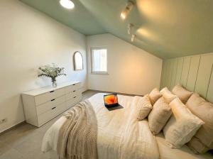 a bedroom with a bed with a laptop on it at Penthouse SKY DELUXE in Novalja +16 photos