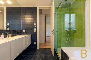 a bathroom with a shower and a sink at BePlace Apartments Arona in Arona +76 photos