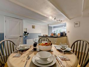 a dining room table with a bowl of fruit on it at 3 Bed in Looe oc-92273 in Polperro