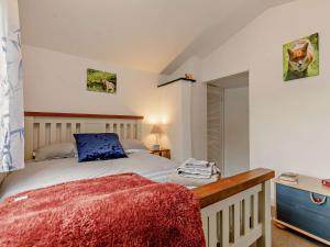 a bedroom with a bed with a blue pillow on it at 3 Bed in Looe oc-92273 in Polperro