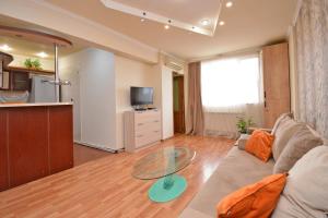 a living room with a couch and a glass table at Apartment On Saryan Street in Yerevan