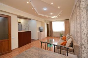 a living room with a couch and a table at Apartment On Saryan Street in Yerevan +9 photos