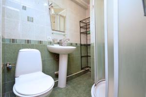a bathroom with a toilet and a sink at Apartment On Saryan Street in Yerevan