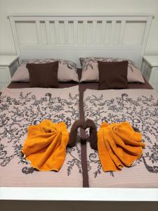 a bed with two orange towels on top of it at Penzion Šedivý in Strachotín +9 photos