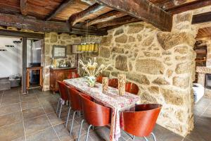a stone walled dining room with a table and chairs at Guest H4U - Nature & Pool Guarda in Seixo Amarelo +33 photos