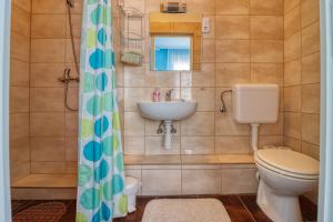a bathroom with a toilet and a sink at Vincze Villa Vendégház in Bükkszék