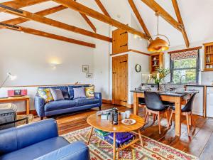 a living room with a blue couch and a table at 2 Bed in Fowey oc-55381 in Golant