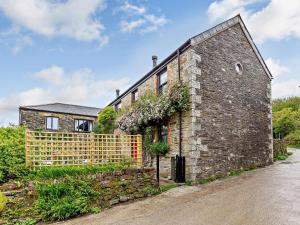 a brick house with a fence in front of it at 2 Bed in Fowey oc-55381 in Golant