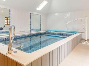 a large swimming pool with a sink and a tub at 2 Bed in Fowey oc-55381 in Golant
