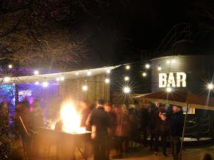 a group of people standing in front of a bar at night at 2 Bed in Fowey oc-55381 in Golant +20 photos