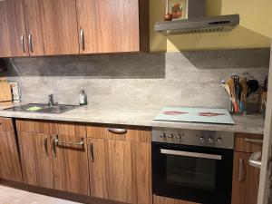 a kitchen with a sink and a stove top oven at Ferienwohnung Panorama in Konz +3 photos