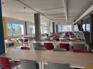 a cafeteria filled with tables and chairs and tables at Alberg Deltebre Xanascat in Deltebre