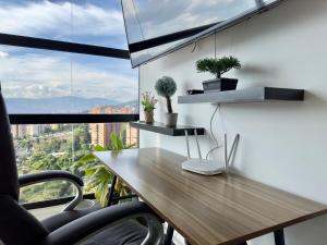 an office with a wooden desk and a window at 2003 Poblado TOP apartamento in Medellín +32 photos