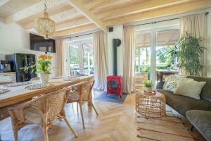 a kitchen and living room with a table and a couch at Krukówka Białogóra & jacuzzi in Białogóra
