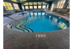 a large swimming pool in a building at Studio 6 Lake George NY Adirondacks in Lake George