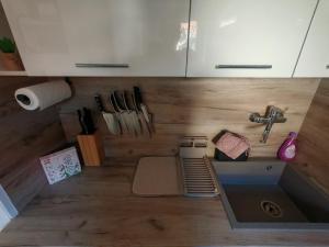a kitchen with a sink and a counter top at Horizon Hill in Cserszegtomaj +13 photos