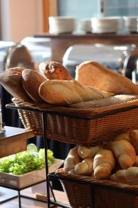 two baskets filled with bread and vegetables on a shelf at Hotel Swing in Krakow
