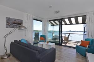 a living room with a couch and a view of the water at Veerse Muze in Kamperland