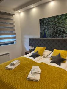 a bedroom with a large bed with yellow sheets and pillows at BalkanHill2 S37 Pekovic green in Zlatibor +161 photos
