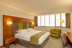 a hotel room with a large bed and a desk at The View Hotel in Eastbourne +64 photos
