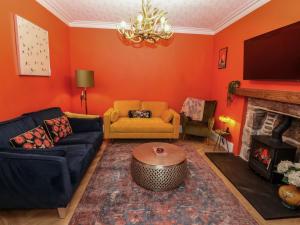 a living room with a couch and a fireplace at Lindean in Ballater