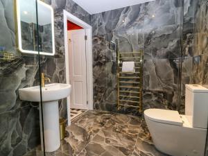 a bathroom with a sink and a toilet at Lindean in Ballater +24 photos