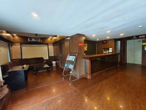 a living room with a couch and a bar at RAILVIEW HOTEL- Nr Platform-1, Railway Station in Bhubaneshwar +21 photos