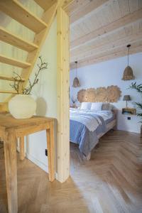 a bedroom with a bed and a wooden ceiling at Krukówka Białogóra & jacuzzi in Białogóra +29 photos