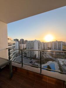 a balcony with a view of a city at Caesar Resort & SPA & Apartments Spacious Studio in Avgorou