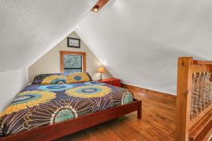 a bedroom with a bed in a attic at The Cabin at Rooster Ridge in Fischer