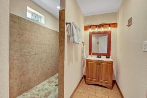 a bathroom with a sink and a mirror at The Cabin at Rooster Ridge in Fischer