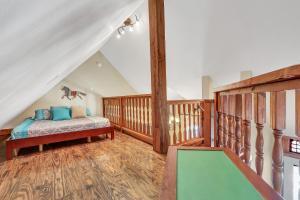 a bedroom with a bed and a staircase in a attic at The Cabin at Rooster Ridge in Fischer +30 photos