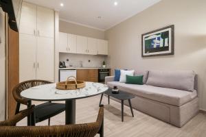 a living room with a couch and a table at Myrina Concept in Myrina +5 photos