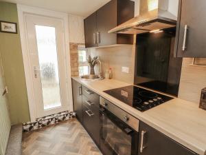 a kitchen with wooden counters and a stove top oven at 25 Low Seaton in Workington
