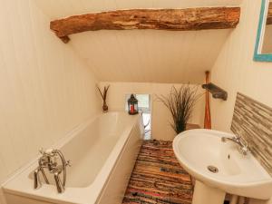 a bathroom with a bath tub and a sink at 25 Low Seaton in Workington +11 photos