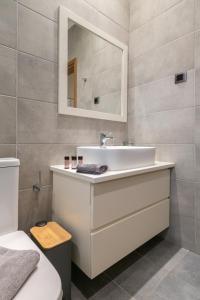 a bathroom with a white sink and a mirror at Myrina Concept in Myrina