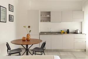a kitchen with a table and chairs in a kitchen at Bob W Rome San Lorenzo in Rome