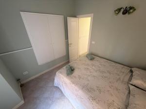 a small bedroom with a bed and a closet at Il Vicolo in Vibo Valentia +3 photos