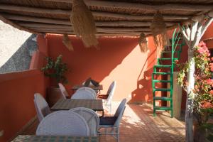 a patio with tables and chairs and a ladder at Riad Ruh Fes in Fez