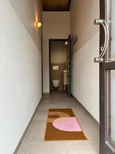 a bathroom with a toilet and a rug on the floor at Spacious Design Home with Garden near Centre in Bruges +17 photos
