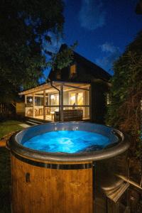 a hot tub in front of a house at Krukówka Białogóra & jacuzzi in Białogóra