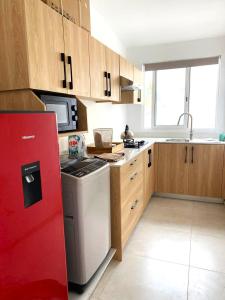 a kitchen with a stove and a red refrigerator at Nulacaz 2 - Centrally located in Rose Hill