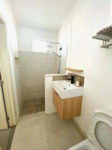 a white bathroom with a sink and a toilet at Nulacaz 2 - Centrally located in Rose Hill