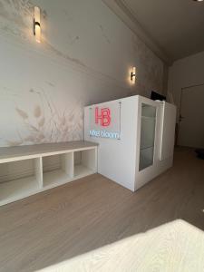 a white desk with a red beacon sign on the wall at Hotel Bloom in Caen +14 photos