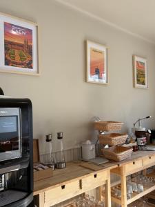 a kitchen counter with a microwave and a television at Hotel Bloom in Caen