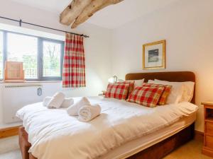 a bedroom with a large bed with towels on it at 3 Bed in Fowey oc-55382 in Golant +19 photos