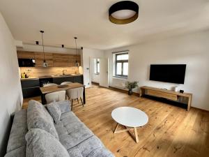 a living room with a couch and a table at Core Apartments Jihlava in Jihlava