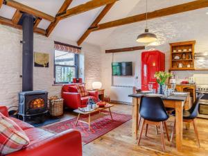 a living room with a table and a fireplace at 2 Bed in Fowey oc-55383 in Golant