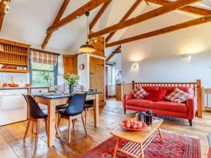a living room with a red couch and a table at 2 Bed in Fowey oc-55383 in Golant
