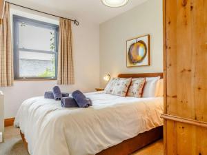 a bedroom with a bed with blue towels on it at 2 Bed in Fowey oc-55383 in Golant +19 photos